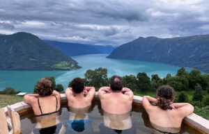 Family soaking in a hot tub with a spectacular view, on a Norway family holiday