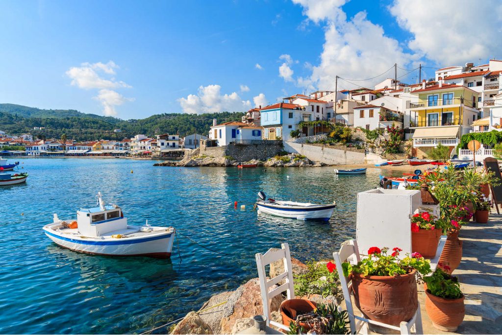 Greece family holidays - island village with tavernas beside blue sea