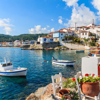 Greece family holidays - island village with tavernas beside blue sea