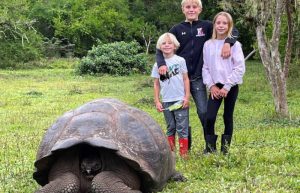 Galapagos family summer holiday - kids with giant tortoise
