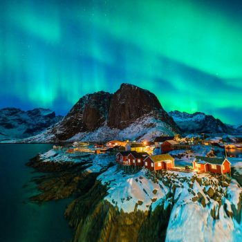 Iceland scene with village, mountains and aurora borealis on Iceland family holiday
