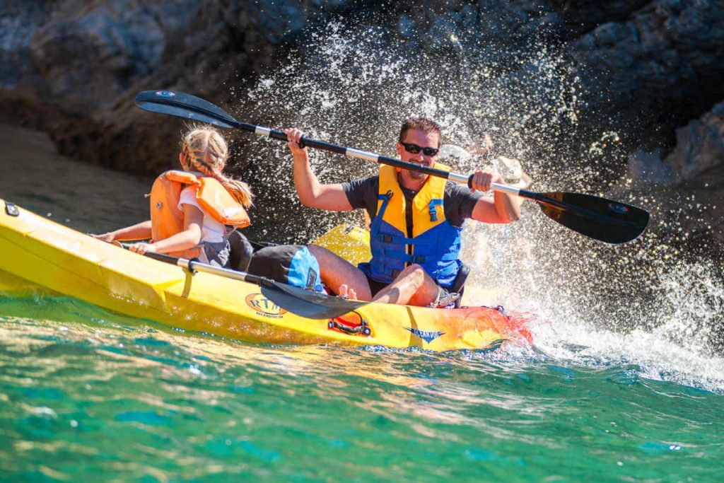 Father and daughter kayaking in Portugal