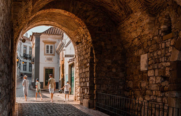 Family exploring narrow backstreets in Portuguese city