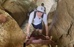 Climbing up ladder in a hidden wadi, Jordan