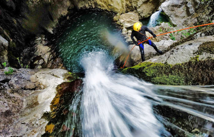Canyoning trips in Montenegro -rapelling down waterfall