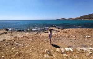 Child exploring hidden beach in Greece