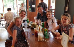 Family with drinks in Thailand cafe - Stubborn Mule travellers