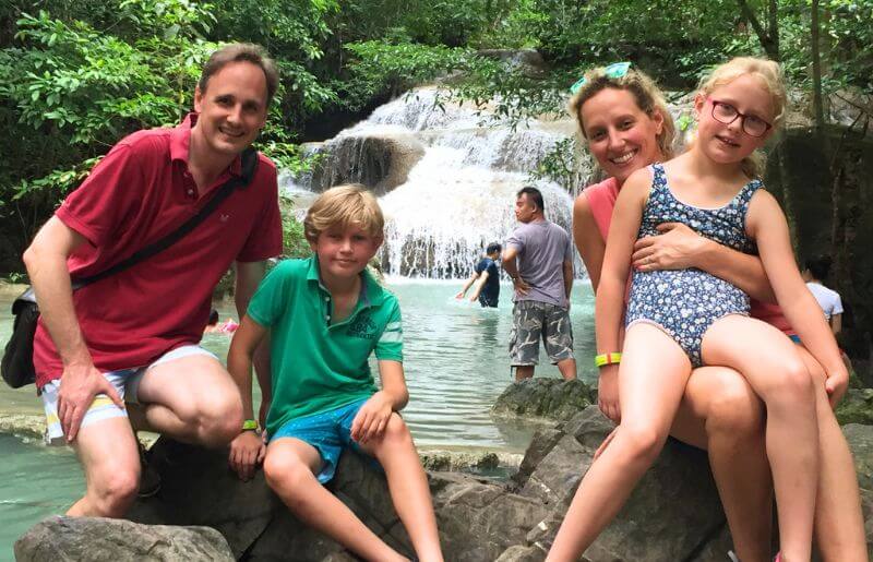 Family sitting beside the Erland River in Thailand