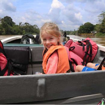 Children on boating trip - Borneo with kids itinerary