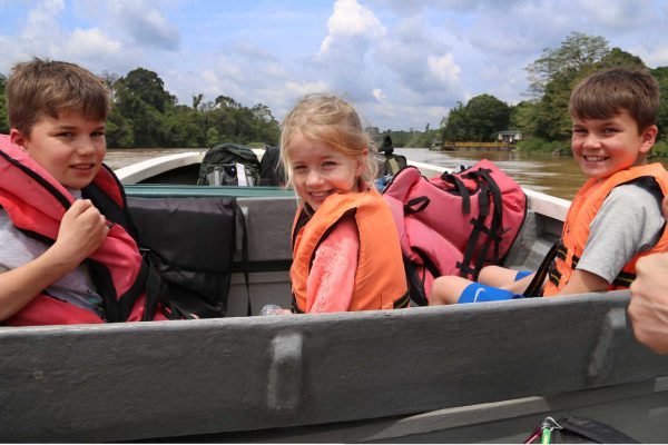 Children on boating trip - Borneo with kids itinerary