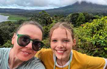 Family on holiday in Costa Rica, Arenal volcano in background