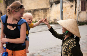 Mother and toddler greeted by Vietnamese woman
