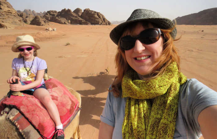 Mother and daughter exploring Wadi Rum, Jordan, by camel