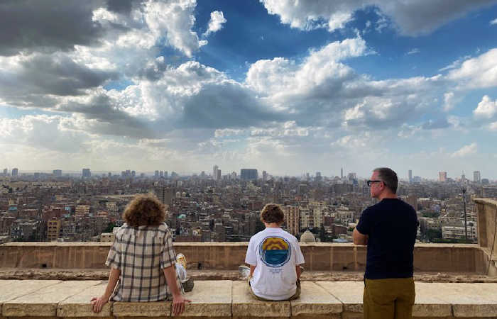 Best cities to visit with kids - family looking over Cairo from viewpoint