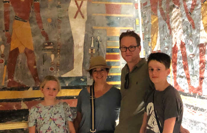 Egypt with kids holiday, family in burial chamber, Valley of the Kings