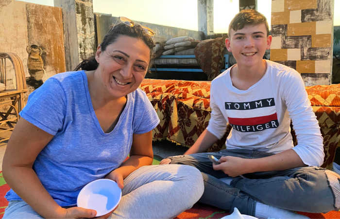 Teenager eating traditional dinner on Egypt with kids adventure