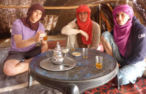 Teenagers in Morocco trying mint tea after a camel ride
