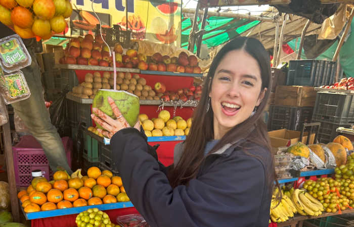 Family buying fresh coconut drink when holidaying in India with kids