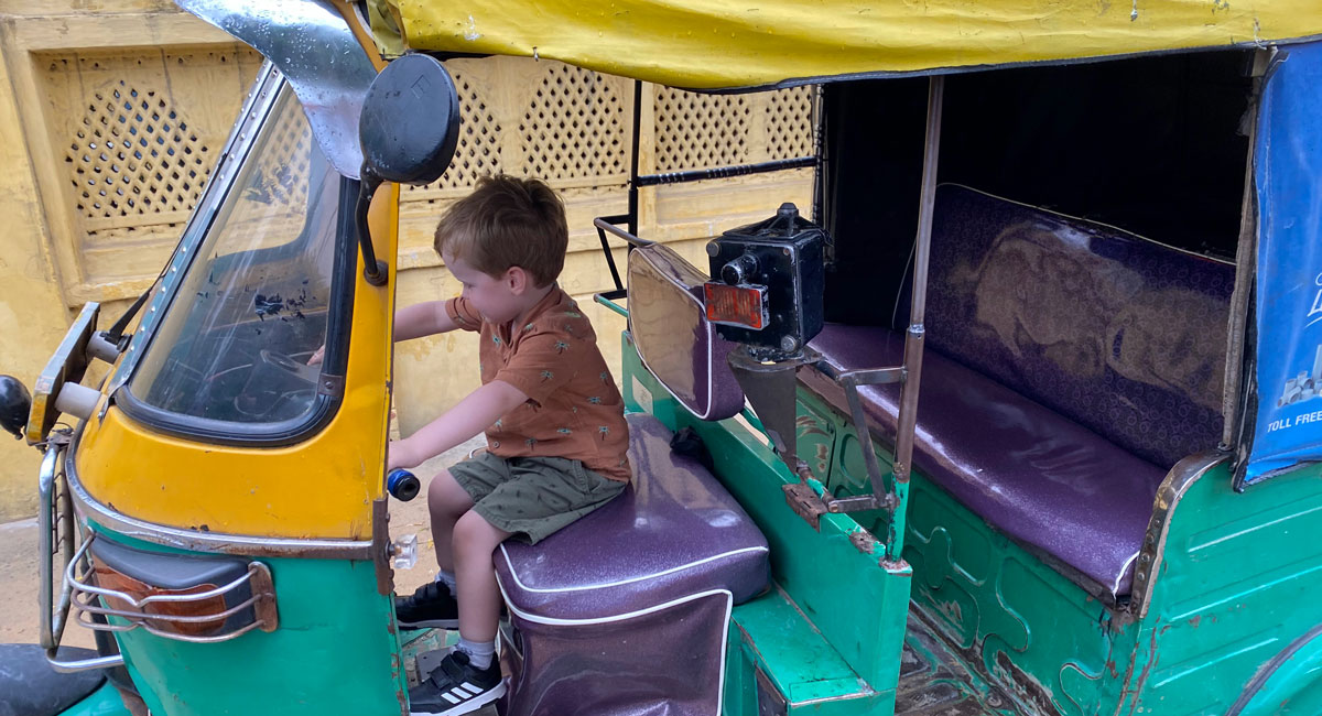 Child playing at driving a tuk tuk