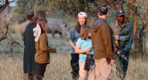 Family group trekking rhinos in Hwange with the Cobra rangers, visiting on Zimbabwe family holidays