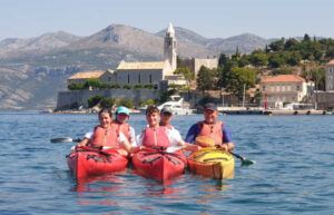 Family with teenagers sea kayaking in Croatia