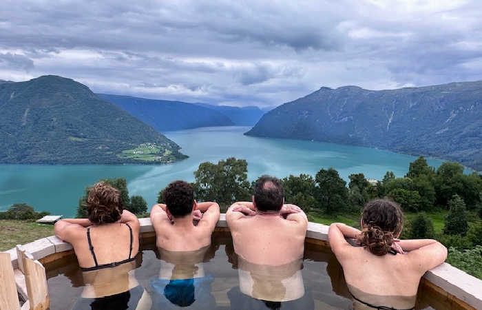 Family in hot tub with s stunning view over a Norwegian fjord