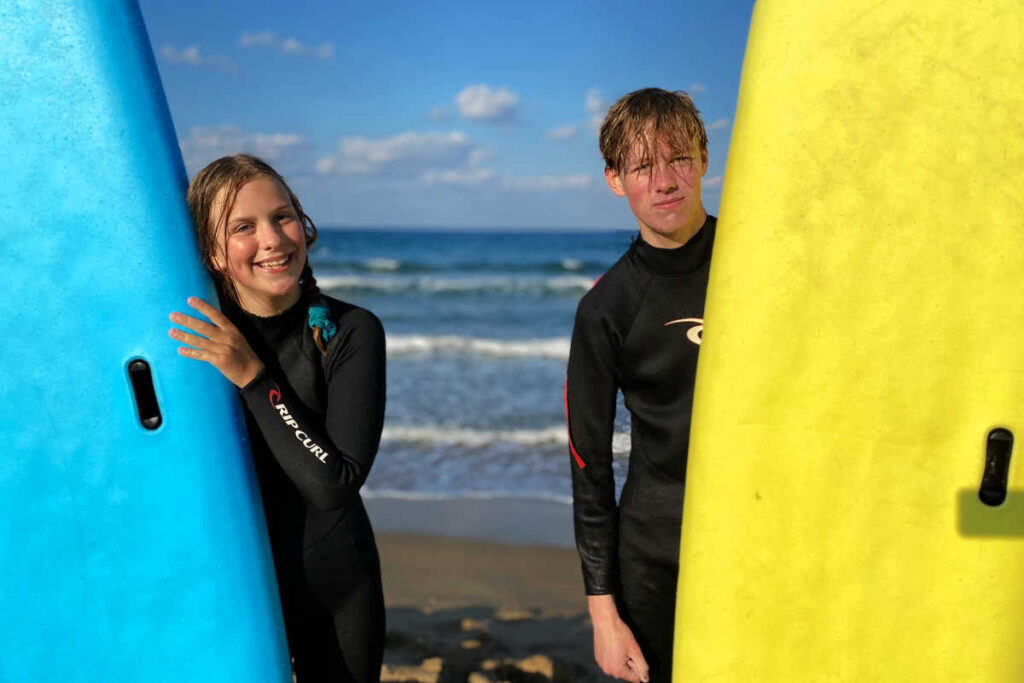 Teenagers surfing in Crete on active Europe family holiday