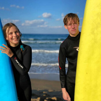 Teenagers surfing in Crete on active Europe family holiday