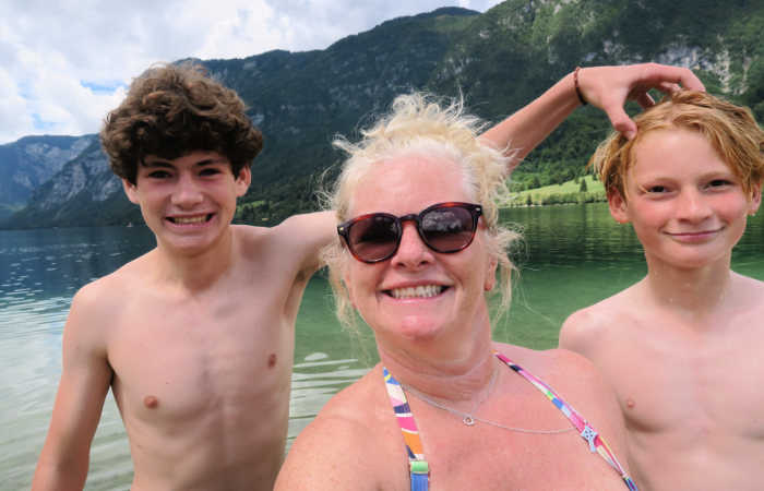 Family swimming in Lake Bohinj, Slovenia, on active family holiday in Europe.