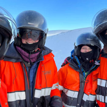 Family snowmobile outing - with red jackets and crash helmets