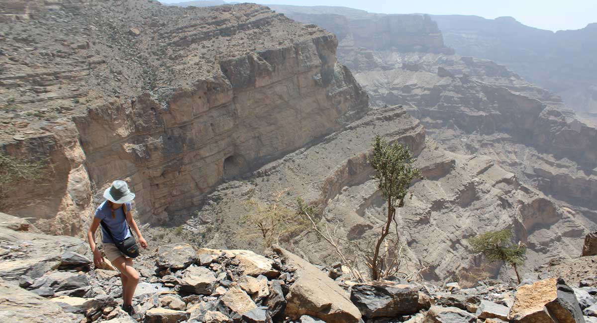 Photos of Oman showing the Balcony Walk with child hiking and tremendous rocky views
