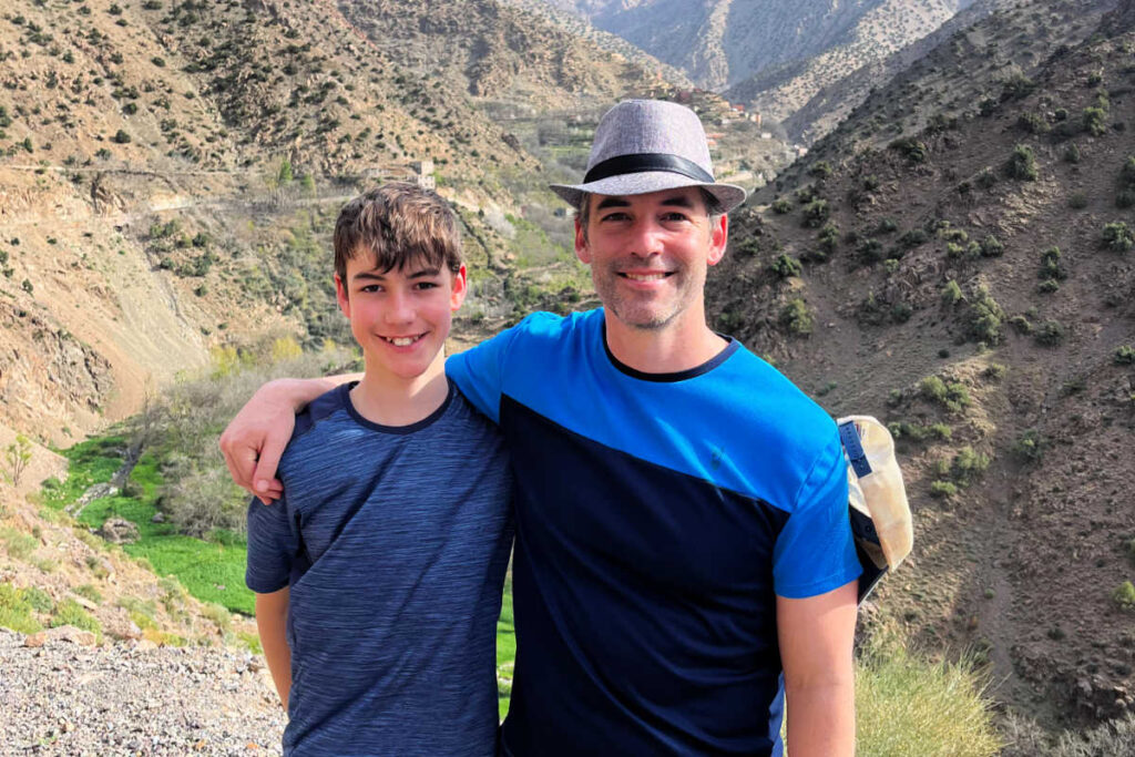 Dad and son hiking in Morocco's mountains