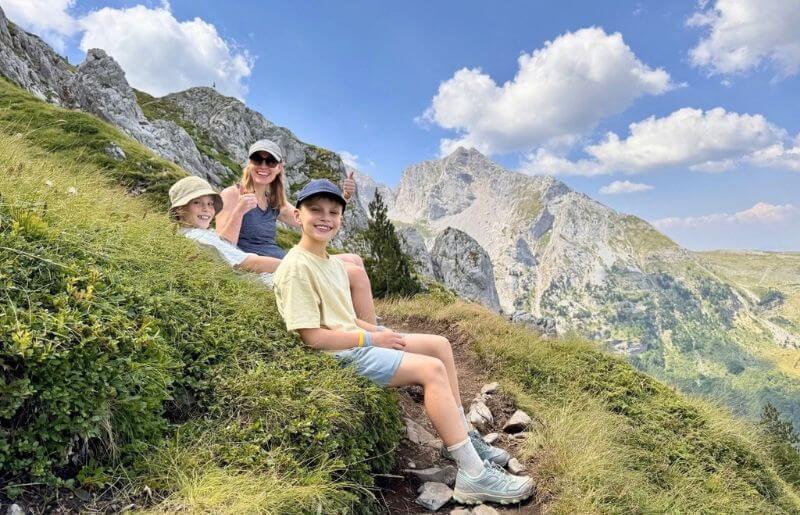 Mother and two sons taking a rest during a hike in the Montenegro mountains