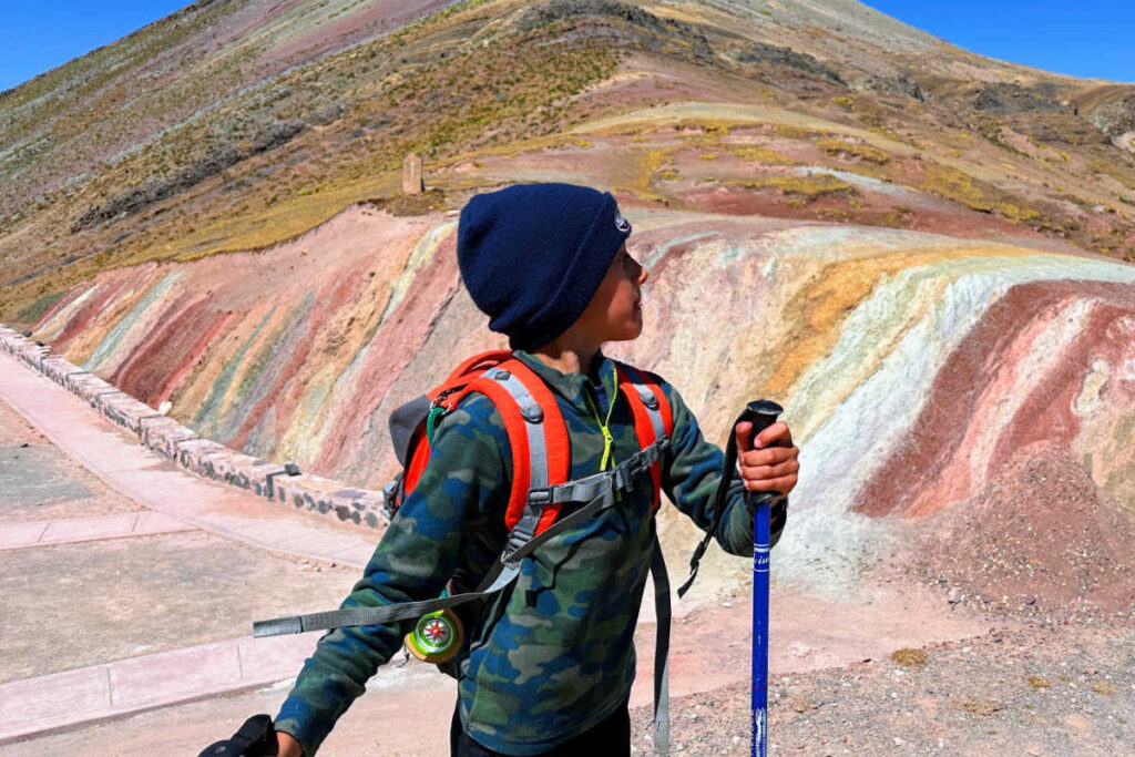 Child exploring Peru's multicoloured hills on Peru with Kids itinerary