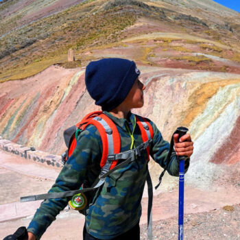 Child exploring Peru's multicoloured hills on Peru with Kids itinerary