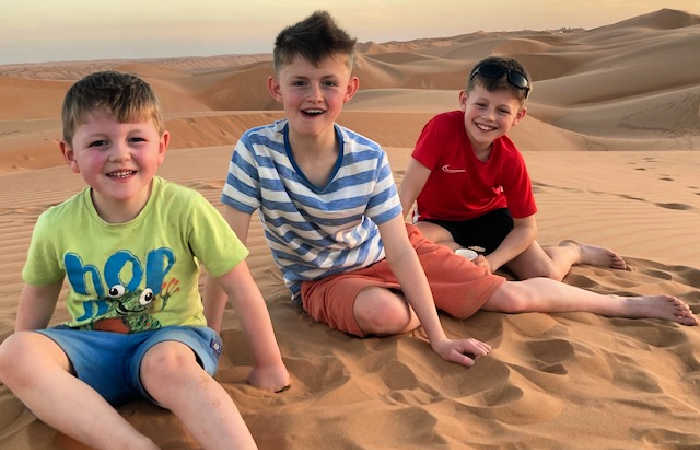 Family of younger children, with an under-5, in the Oman desert