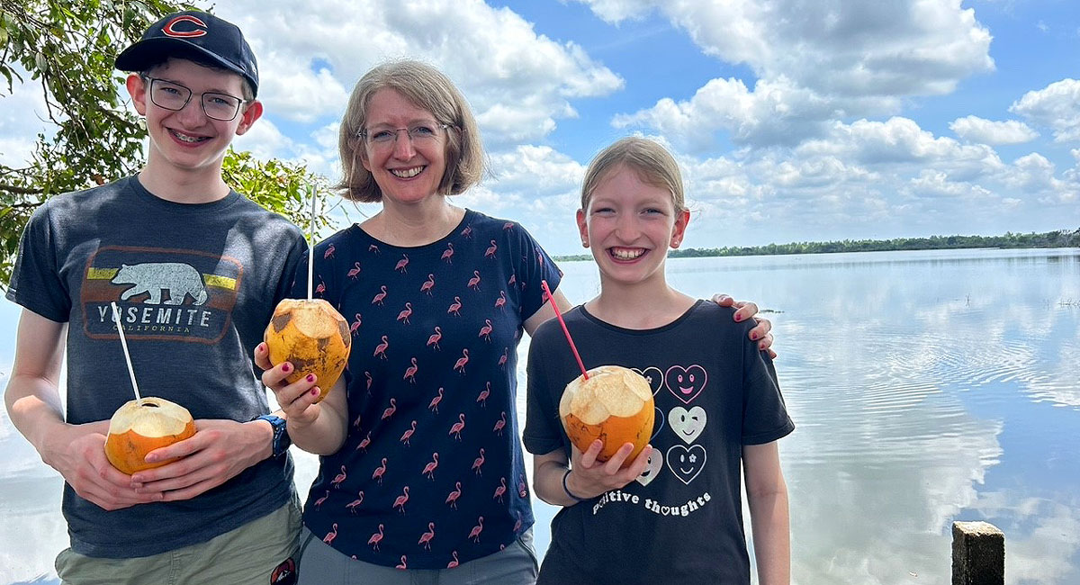 Families drinking from King Coconuts, Sri Lanka