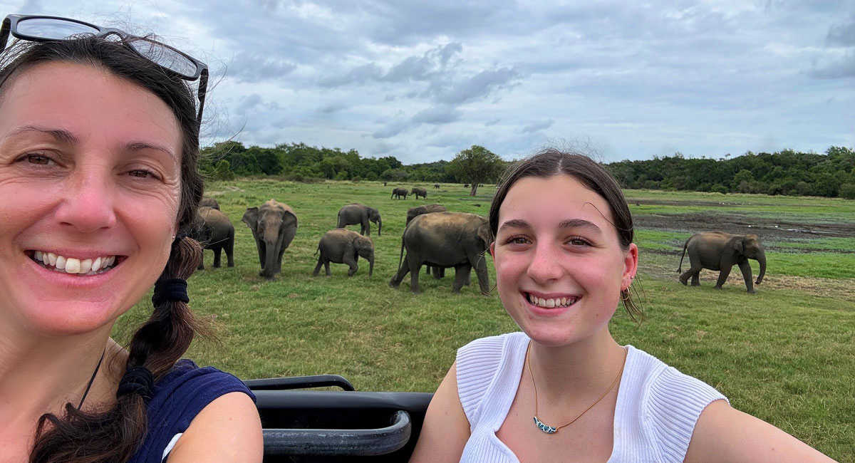 Mother and daughter on safari, spotting elephants