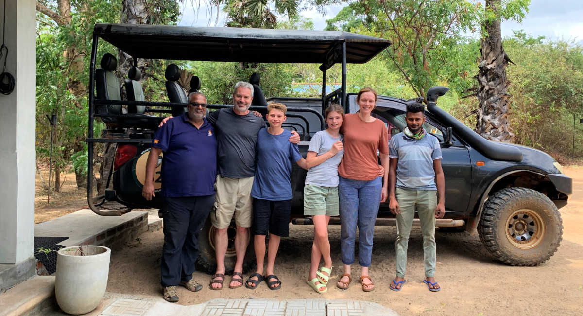 Family with driver and guide in Sri Lanka, with open top vehicle