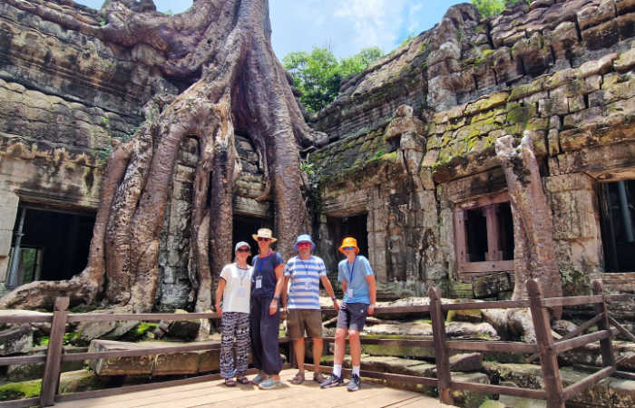 Family exploring Angkor temple, top Asia holiday destination
