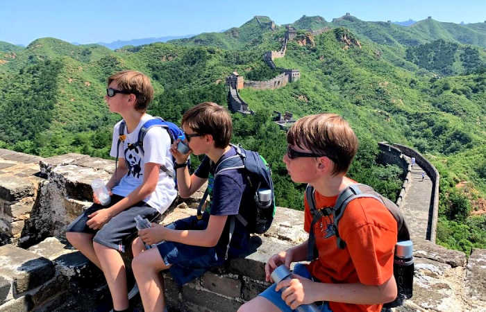 Boys on Great Wall of China on Asia holiday