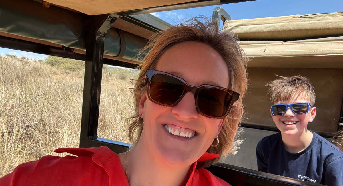 Family on safari, grassy plains of the Mara