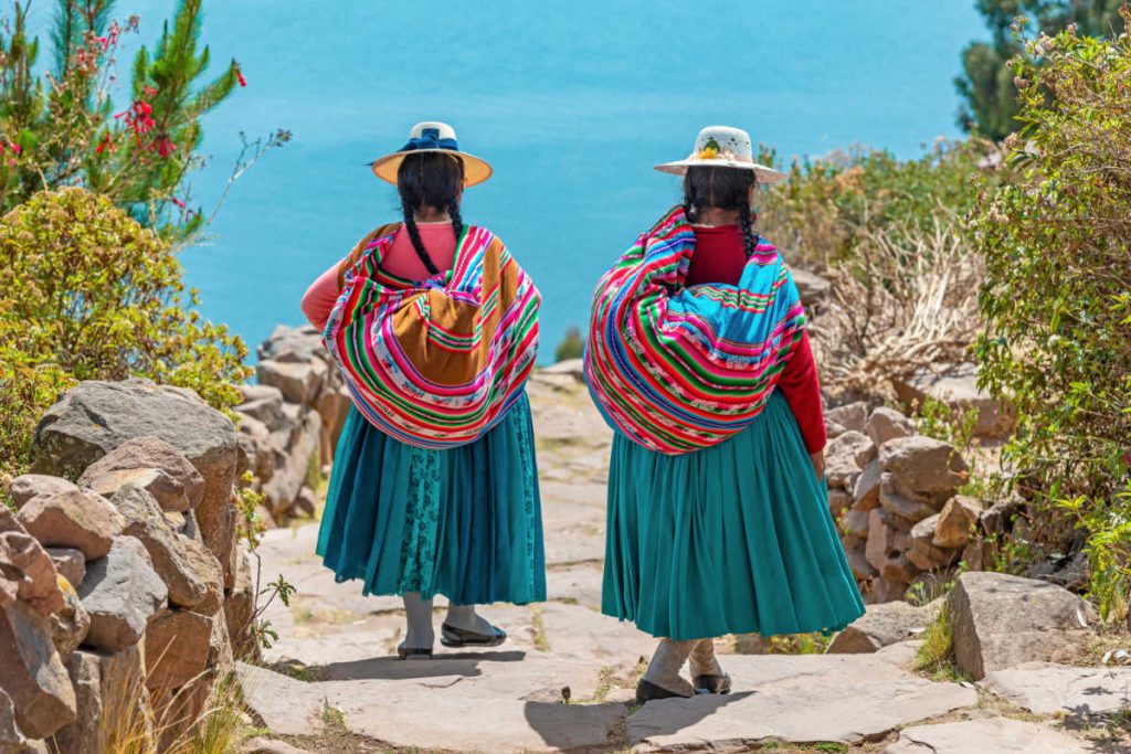 Two Peruvian women at Lake Titicaca, Latin America family travel guide