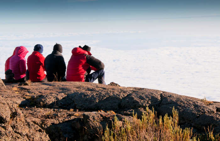 Group looking at the views from above the clouds on Kilimanjaro climb