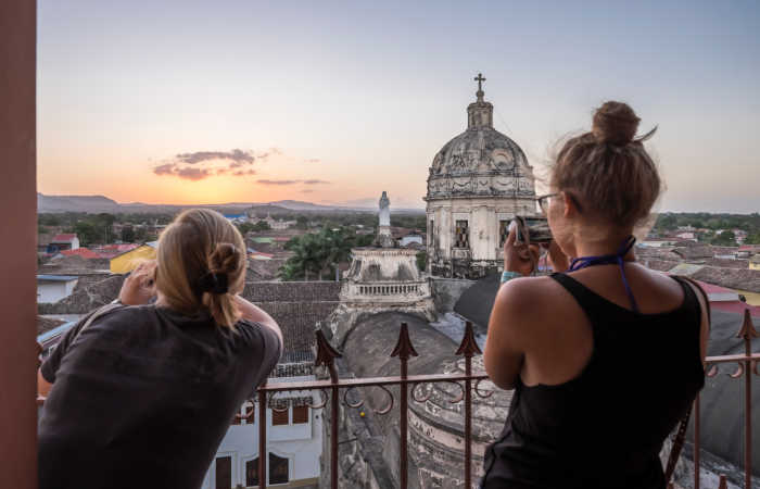 Teenagers sightseeing in Granada, Nicaragua, at sunset