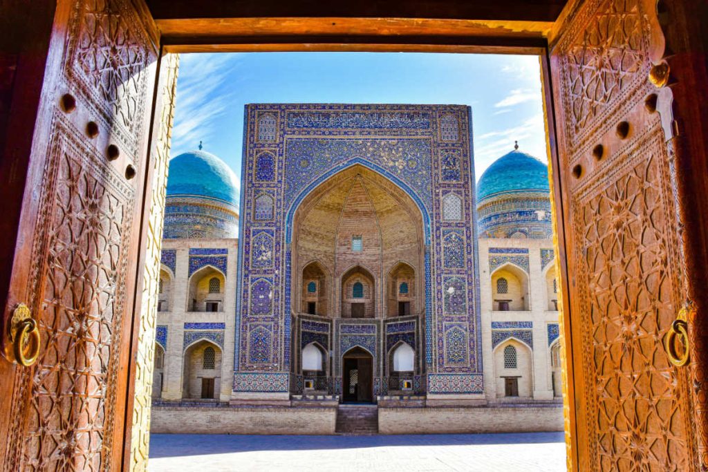 View of Bukhara through wooden carved doors, Uzbekistan with kids holidays