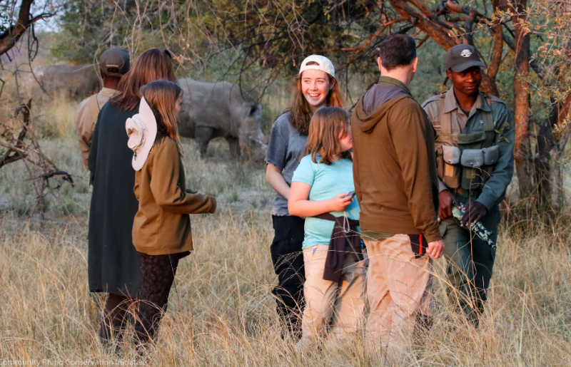 Family walking safari with Cobra rangers in Zimbabwe, Africa, protecting vulnerable rhinos.