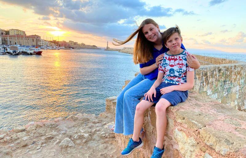 Kids on a family summer holiday in Crete - with sun setting in the background