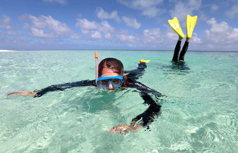 Teenager snorkelling in turquoise sea, Australia, on Easter holiday break