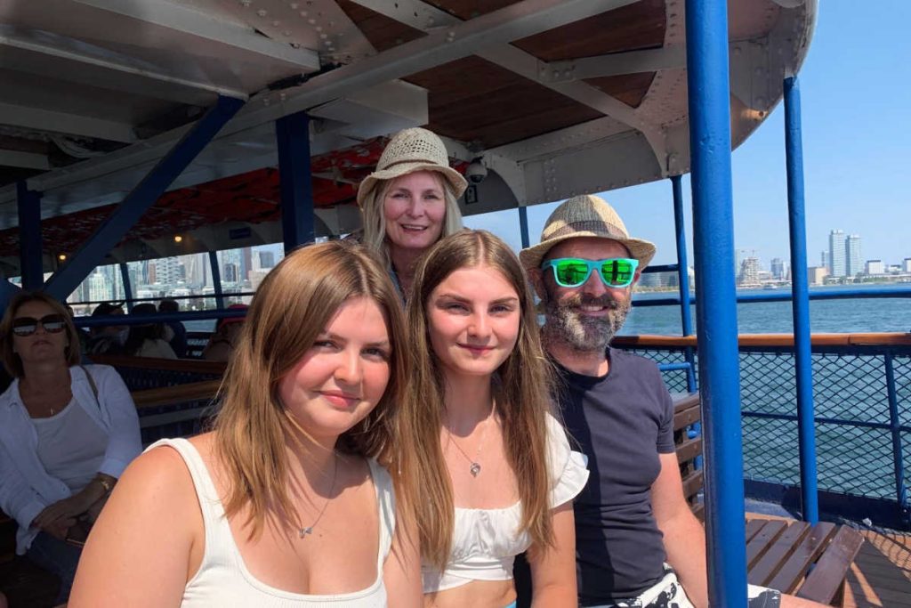 Family on ferry in Toronto, Canada, with blue sky and bright sun, one of our recommendations from Stubborn Mule staff for 2026 family holidays